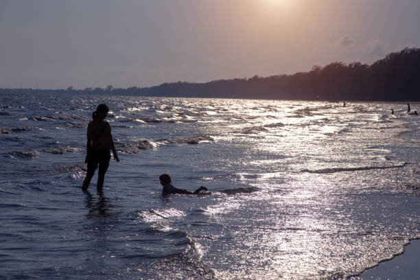 istock People At Beach Against Sky During Sunset 1188876937