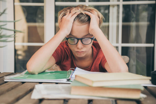 istock Exhausted Boy Looking At Books 1188878780
