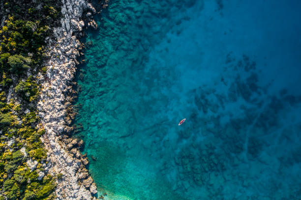 istock Woman kayaking clear turquoise sea 1188879848