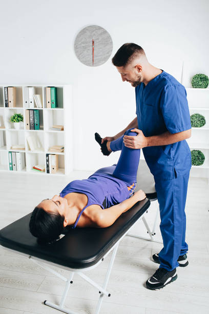 istock woman visiting her physiotherapist. Patient doing exercise for treatment joint. 1188880191