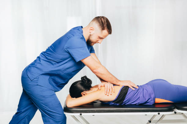 istock Physiotherapist giving back massage to female patient 1188880209