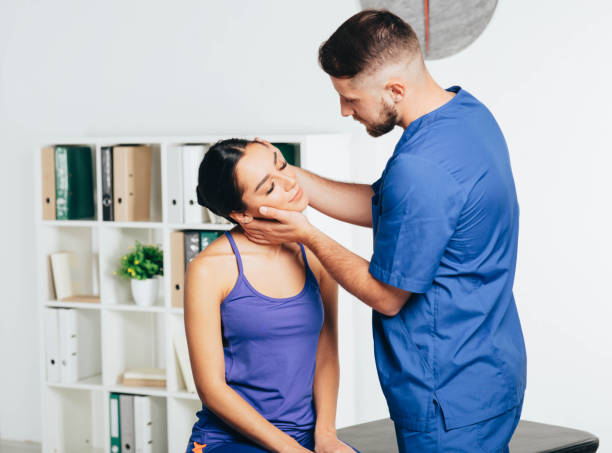 Woman rehab with her physiotherapist. cervical vertebra treatment with exercise Woman rehab with her physiotherapist. cervical vertebra treatment with exercise cervical vertebrae photos stock pictures, royalty-free photos & images