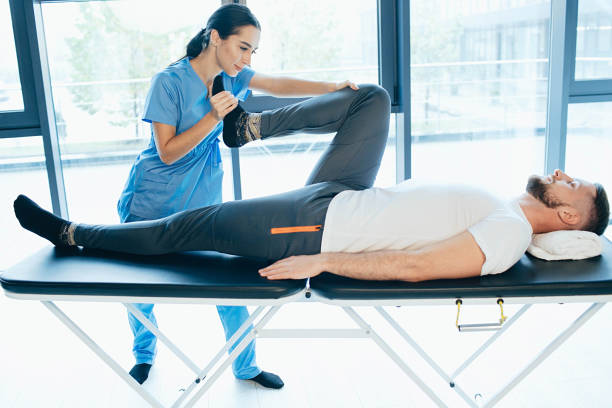 istock man treat lumbar disc. man lying on massage table while his physical therapist doing special exercises for physical therapy for sciatica and pinched nerve problems 1188881064