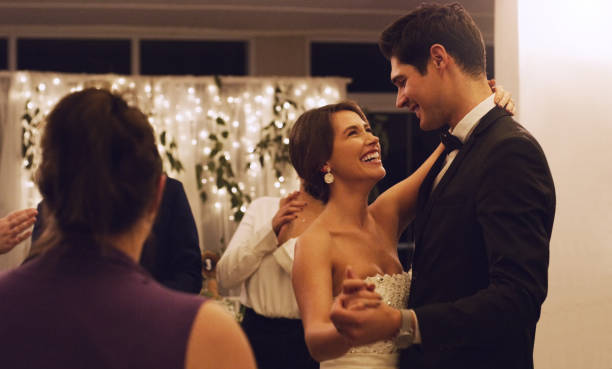 Cropped shot of an affectionate young newlywed couple dancing in front of their guests at their wedding reception