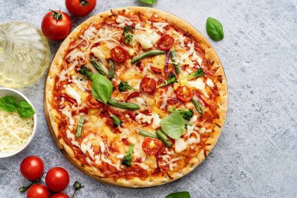 istock Fresh vegetarian pizza on light blue background 1188881765