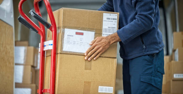 istock Delivery man stacking packages on cart 1188881806