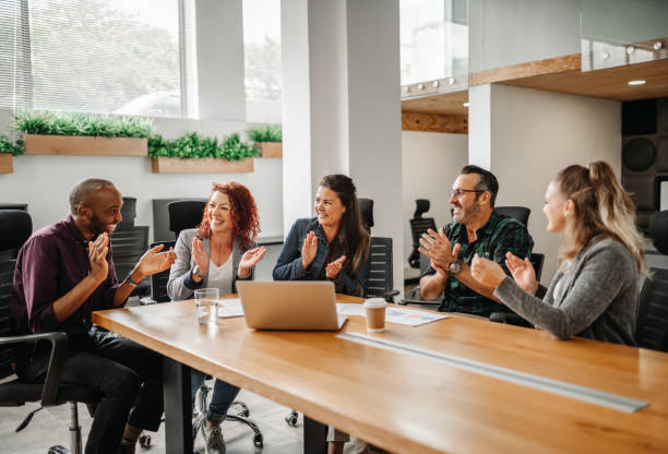 istock Diverse business team clapping hands and smiling during boardroom meeting 1188882009
