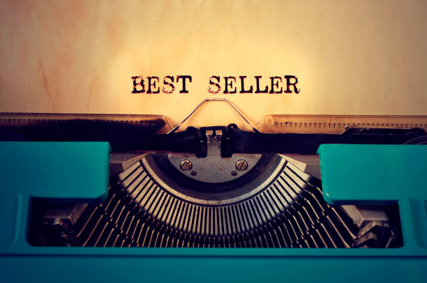 retro typewritter and text best seller written with it closeup of a blue retro typewritter and the text best seller written with it in a yellowish foil best sellers stock pictures, royalty-free photos & images
