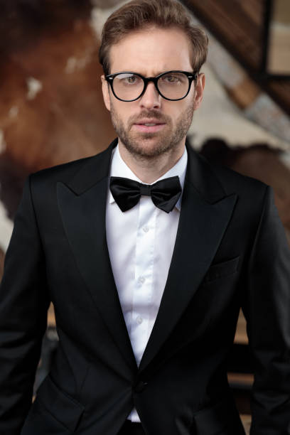 istock Young groom looking forward while wearing tuxedo and glasses 1188882895