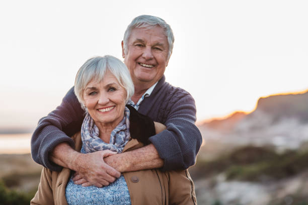 istock Affectionate senior couple smiling while standing together at the beach 1188884564