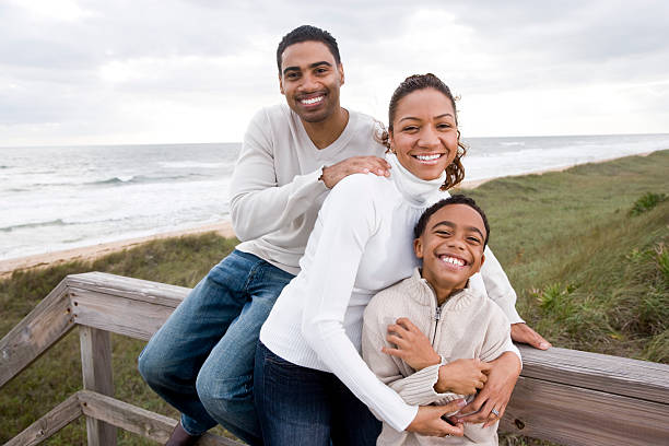 African-American family smiling and hugging at beach  10 11 years photos stock pictures, royalty-free photos & images