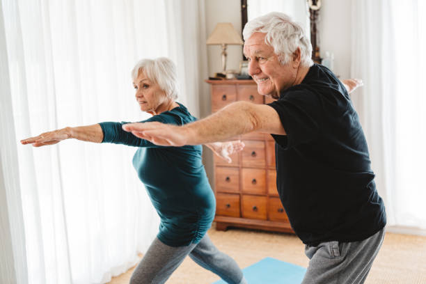 istock Active senior couple doing the warrior pose together at home 1188886908