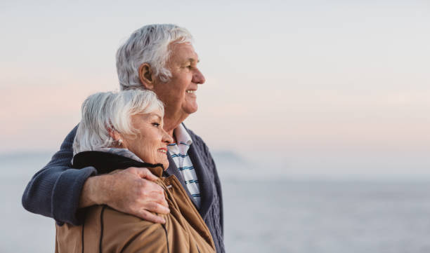 istock Smiling senior couple looking out at the ocean view 1188889575