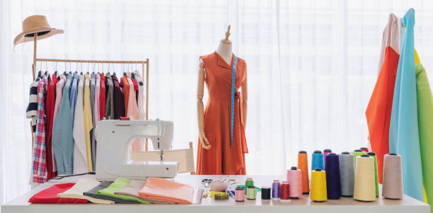 Fashion designer working studio, with sewing items and materials on working table Fashion designer working studio, with sewing items and materials on working table atelier fashion photos stock pictures, royalty-free photos & images