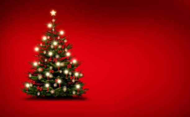 istock Brightly decorated Christmas tree isolated on red  background 1188893487