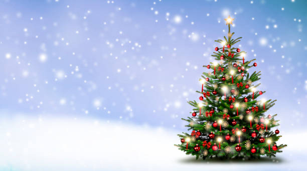 istock Brightly decorated Christmas tree in snowy winter landscape 1188893516