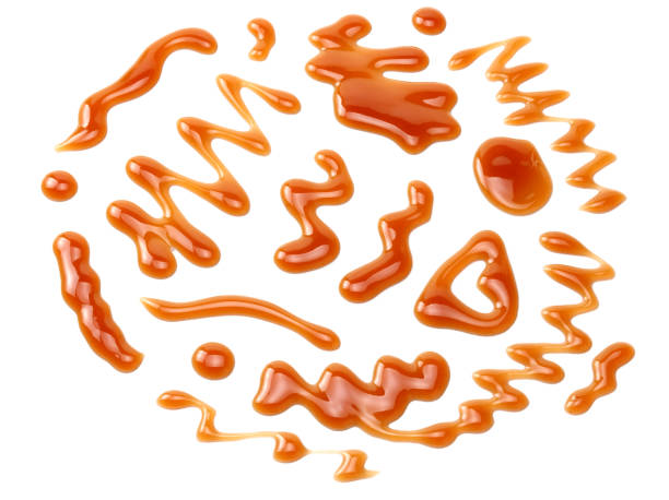 istock caramel sauce isolated on white background. caramel wave 1188898160