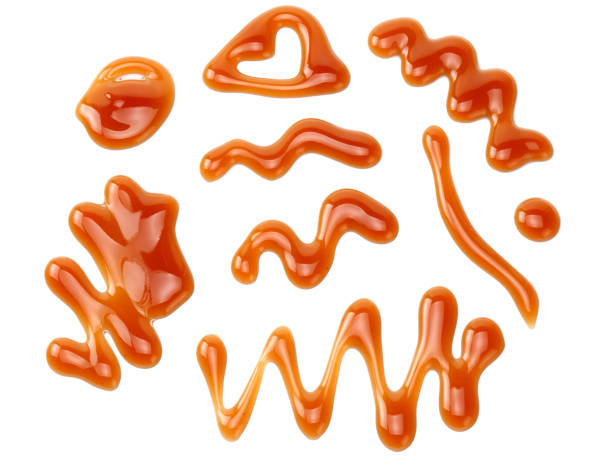 istock caramel sauce isolated on white background. caramel wave 1188898172