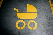 Family only parking sign, baby stroller painted in yellow