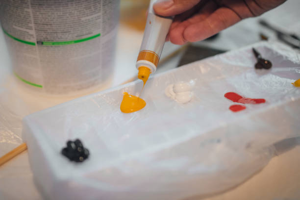 istock Tube with yellow acrylic paint squeezed out on a table 1188899272
