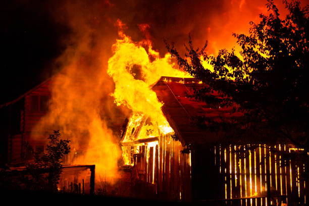 istock Wooden house or barn burning on fire at night. 1188899347