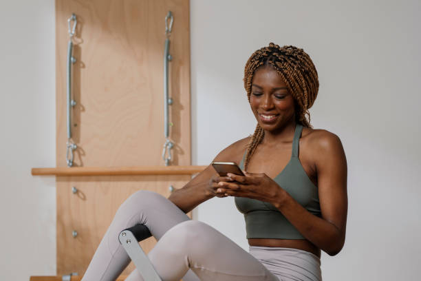 istock Sportswoman using Cell Phone at Gym 1188900742