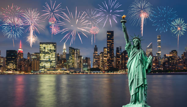 Manhattan at night and statue of liberty with fireworks Statue of liberty in front of Manhattan skyline, at night, during blue hour,with fireworks new years eve new york stock pictures, royalty-free photos & images