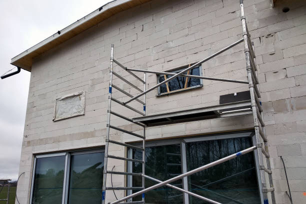 istock Facade of building made from white blocks with big windows under construction works. 1188903771