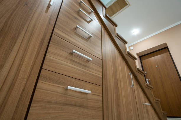 istock Modern architecture interior with luxury hallway with glossy wooden stairs in multi-storey house. Custom built pullout cabinets on glides in slots under stairs. Use of space for storage. 1188903790