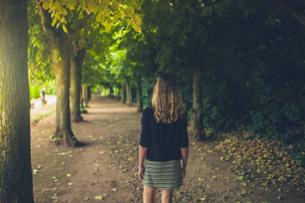 istock Young woman walking in the park 1188905051