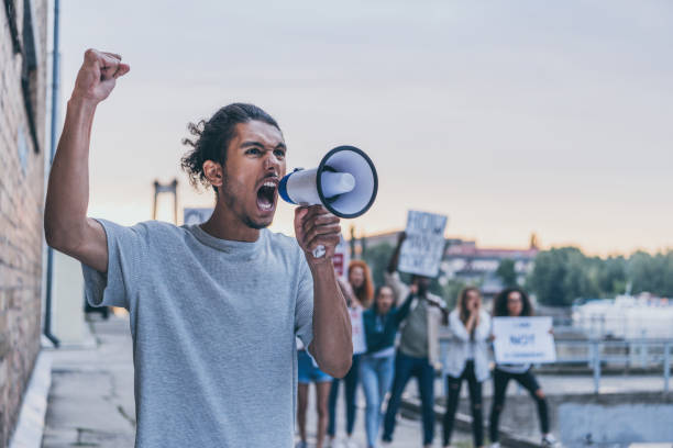 istock selective focus of african american man screaming while holding megaphone 1188905666