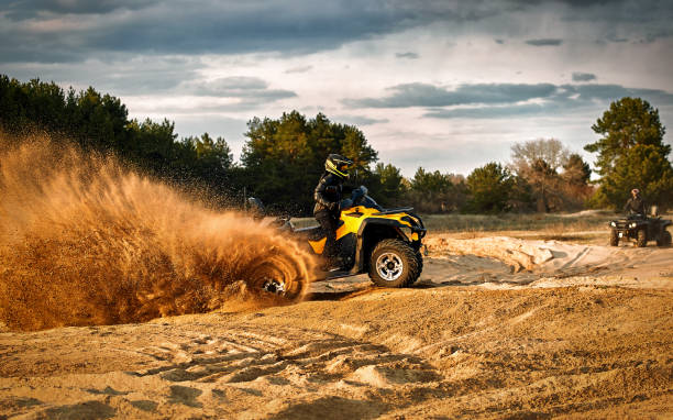 istock Racing powerful quad bike on the difficult sand in the summer. 1188905938