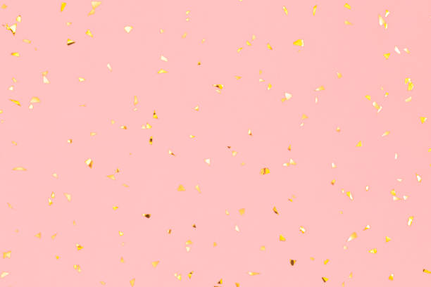istock Golden falling confetti on pink background. Christmas concept. Flat lay, top view 1188908603