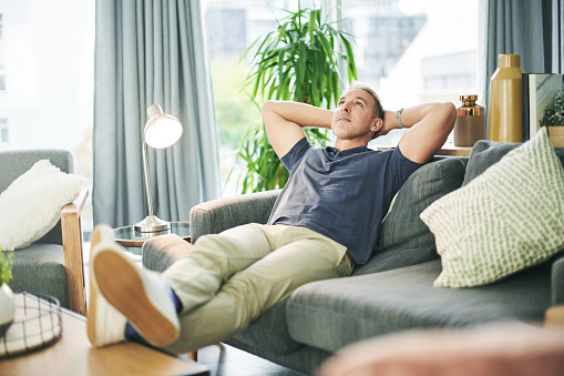 Shot of a man relaxing on the sofa at home