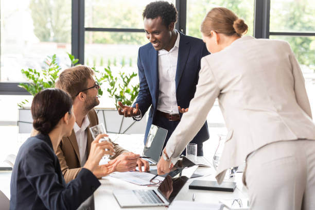 istock smiling multiethnic businesspeople at table during conference in office 1188909817