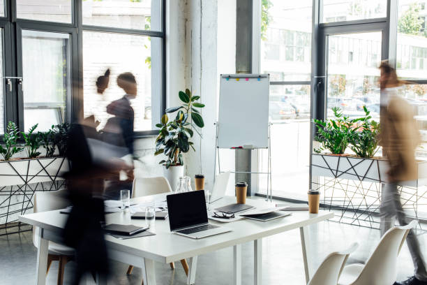 istock silhouettes of three multiethnic colleagues working and walking in office 1188909828