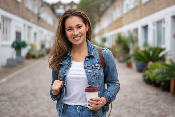 istock Happy woman outdoors drinking a coffee on the go 1188910182