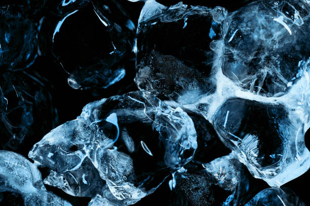 istock frozen transparent ice cubes with blue lighting isolated on black 1188910549