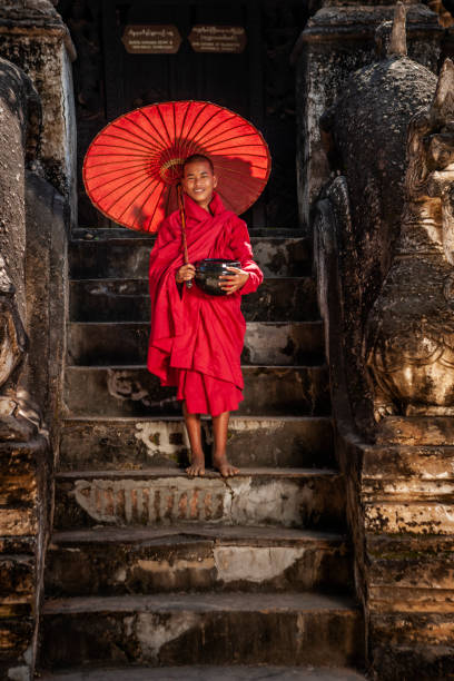 istock Young Buddhist monk standing next to temple, Bagan, Myanmar 1188911548