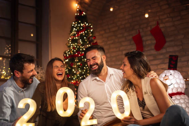 istock Friends celebrating New Year holding illuminative numbers 2020 1188911657