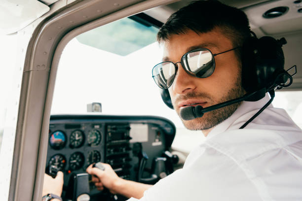istock pilot in sunglasses and headset looking at camera in plane 1188912496