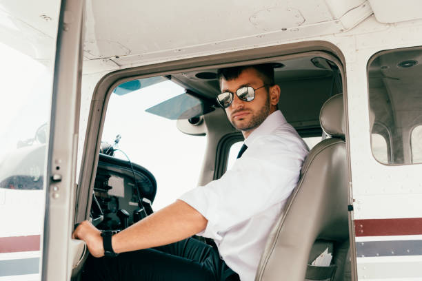 istock handsome pilot in white shirt and sunglasses in plane 1188912505