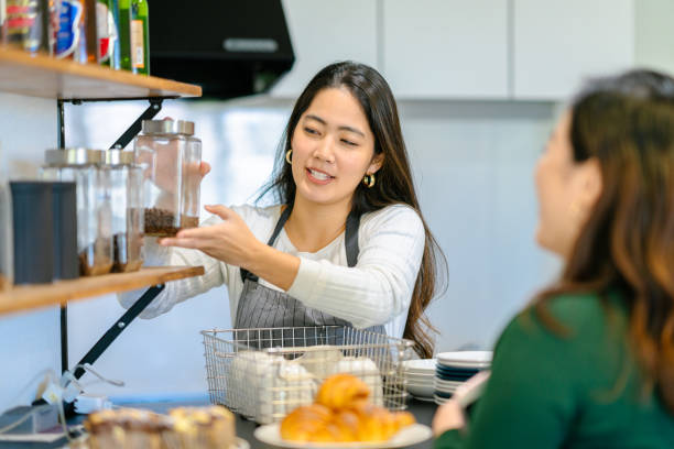 istock Young female cafe owner explaining coffee beans 1188915626