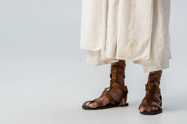 istock cropped view of man standing in sandals on grey 1188915766