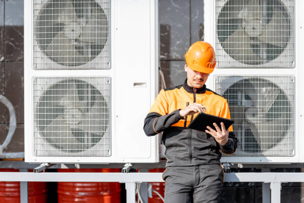 istock Workman servicing air conditioning or heat pump with digital tablet 1188915833