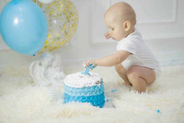 istock One year old child with a birthday cake. First birthday 1188919445