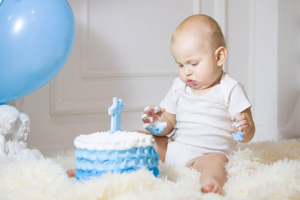 istock One year old child with a birthday cake. First birthday 1188919490