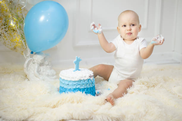 istock One year old child with a birthday cake. First birthday 1188919498