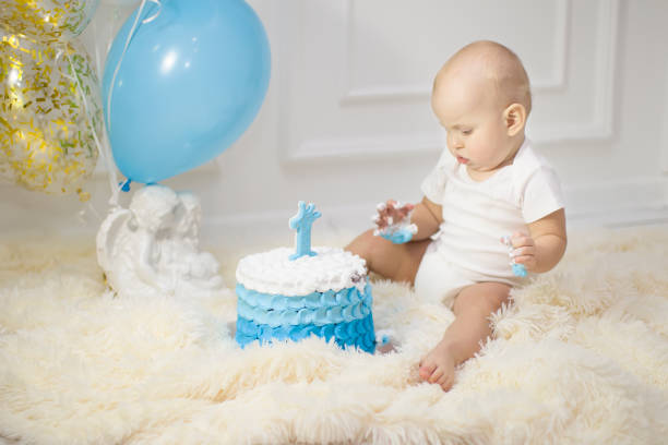 istock One year old child with a birthday cake. First birthday 1188919548