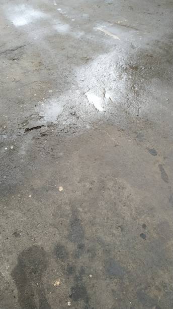 istock puddle and oil stains on dark asphalt 1188920775